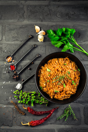 Mince. Marinated Ground meat with ingredients for cooking on black background. Top viewの写真素材