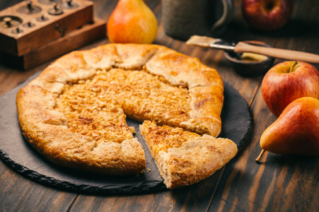 Homemade Galette Pie with Apples and Pears with baking ingredientsの写真素材