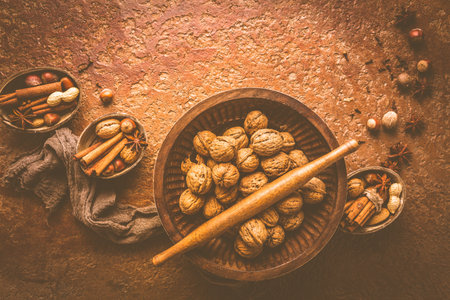 Assortment of different spices and nuts for Christmas baking in warm brown toneの写真素材