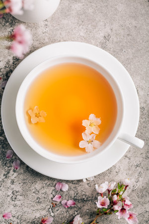 Tea with cherry blossom petals - Sakura tea in white cupの写真素材