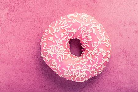 Donut with icing on pastel pink background. Sweet donuts.の写真素材