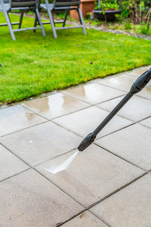 Detail of cleaning terrace with high-pressure water blaster, cleaning dirty paving stonesの写真素材