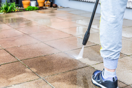 Detail of cleaning terrace with high-pressure water blaster, cleaning dirty paving stonesの写真素材