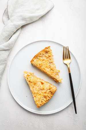 Two pieces of homemade apple pie with nuts on a plate.の写真素材
