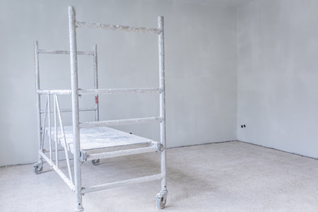 Painting walls in room with ladder during renovationの写真素材