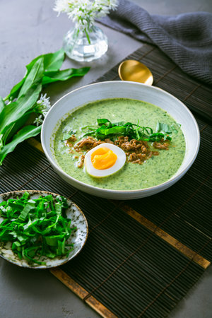 Wild garlic soup, bear leek soup (ramson soup) with boiled eggの写真素材