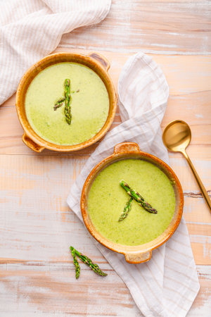 Creamy asparagus soup on wooden backgroundの写真素材