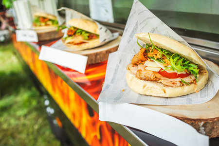 Tray with assorted hamburgers and burgers. Food truck at street food festival.の写真素材
