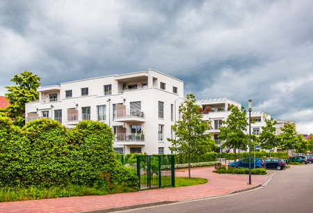 Suburban residential street with modern houses and green parkの写真素材