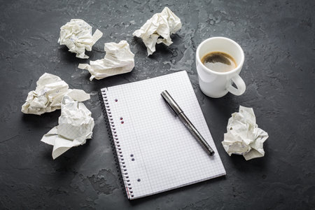 Crumpled wads, sheet of white paper, coffee and idea, brainstorming concept.の写真素材