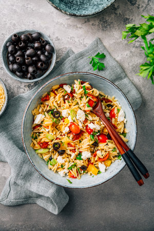 Homemade orzo pasta salad with feta, olives, tomatoesの写真素材