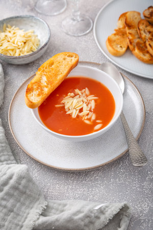Greek tomato soup with orzo pasta and ciabatta breadの写真素材