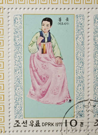  NORTH KOREA - CIRCA 1977  a stamp from North Korea shows image of a woman in traditional North Korean costume, circa 1977 のeditorial素材