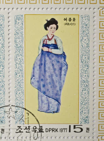  NORTH KOREA - CIRCA 1977  a stamp from North Korea shows image of a woman in traditional North Korean costume, circa 1977 のeditorial素材