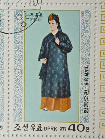  NORTH KOREA - CIRCA 1977  a stamp from North Korea shows image of a woman in traditional North Korean costume, circa 1977 のeditorial素材