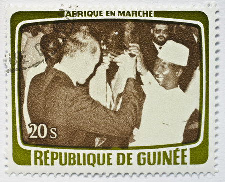Stamp from Guinea shows image of a foreign dignitary and local host dancing, from the Africa in...