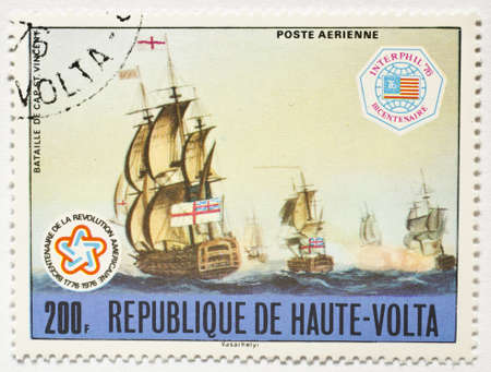  UPPER VOLTA - CIRCA 1976  a stamp from Upper Volta  present day Burkina Faso  shows image of the Battle of Cape St  Vincent and commemorates the US bicentennial, circa 1976 のeditorial素材