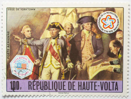  UPPER VOLTA - CIRCA 1976  a stamp from Upper Volta  present day Burkina Faso  commemorates the US bicentennial and shows the Siege of Yorktown, circa 1976 のeditorial素材
