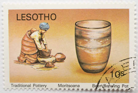 LESOTHO - CIRCA 1980  a stamp from Lesotho shows image of a beer brewing pot, from the traditional pottery series, circa 1980 の写真素材