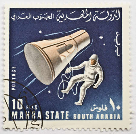  MAHRA SULTANATE - CIRCA 1967  A stamp from Mahra Sultanate  present day Yemen  shows image of an astronaut and a space probe, possibly commerorating the Gemini Project, circa 1967 のeditorial素材