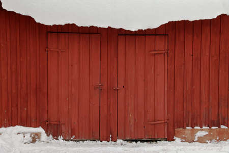 Red shed in winter snowの写真素材