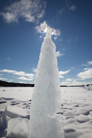  crackled ice pillar against a blue skyの写真素材