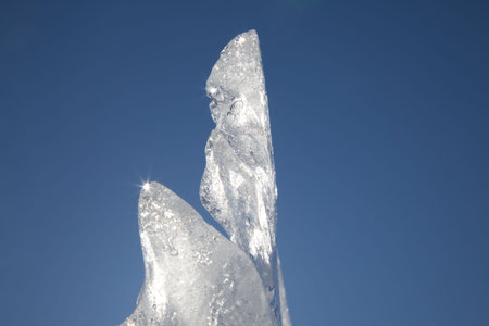 beautiful ice sculpture against a bright blue skyの写真素材