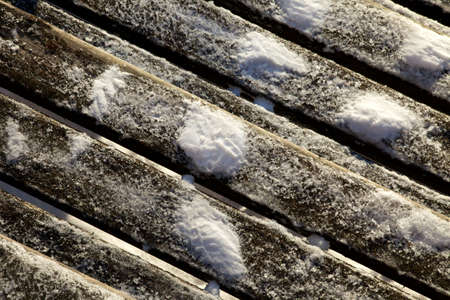 Footsteps in the snow on a wooden bridgeの写真素材