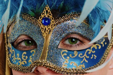 Portrait of the young woman in a carnival to a mask, a close upの写真素材