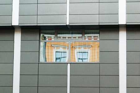 Reflection of the ancient house in windows modern  in Rigaの写真素材