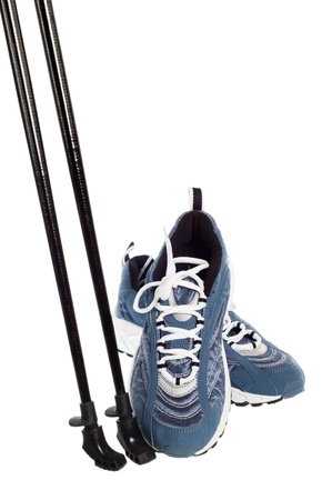 sticks for Nordic walking and  sports shoes  isolated on whiteの写真素材