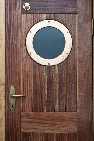Old ship door with a windowの写真素材