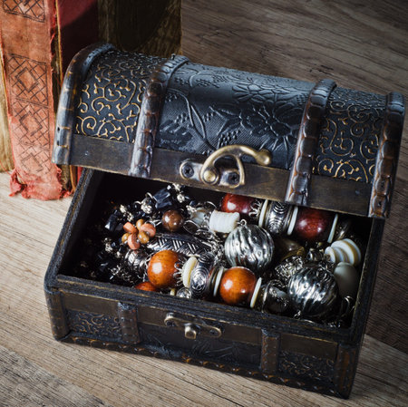casket with jewelry and old book on a wooden surfaceの写真素材