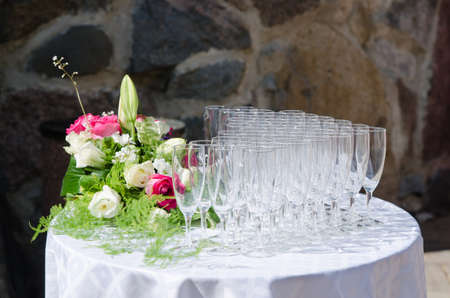 Bouquet of flowers and wine glasses for a wedding tableの写真素材