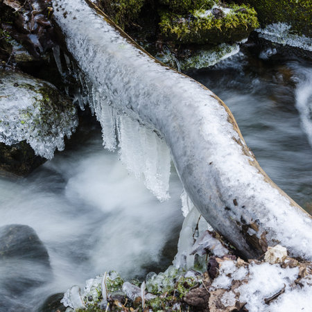Frozen icicles on water flow