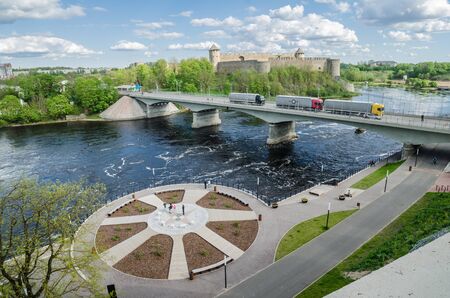 NARVA, ESTONIA - MAY 22 2015: Narva river embankment and a beautiful view of the Ivangorod Fortress and the border of Russia and the European Unionのeditorial素材