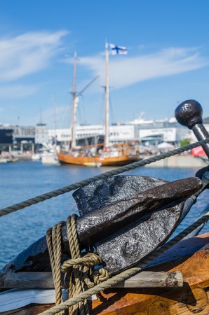Old rusty anchor at a board of the old sailboatの写真素材