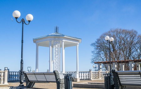 A beautiful romantic gazebo in the park on blue sky backgroundの写真素材