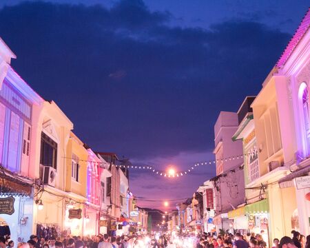 PHUKET, THAILAND January 28, 2018: Tourists shop at the old town night market (walking street) among old building Chino Portuguese style, street of Phuket town in Phuket, Thailand.のeditorial素材