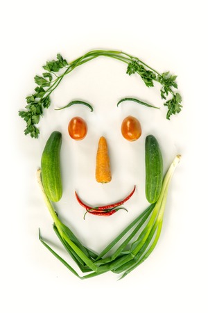 Top view of various fresh vegetables face shape isolated on white, vegetarianの写真素材