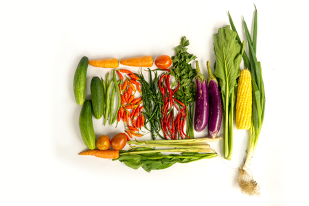 Top view of various fresh vegetables and herbs isolated on whiteの写真素材