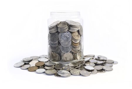 Saving idr coins in the glass bottle jar for finance investment or charity on white backgroundの写真素材