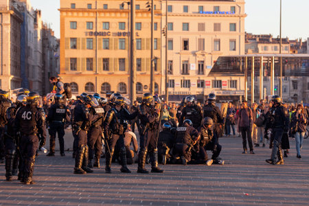 Marseille, France - March 23 2019: Policemen in riot gear with helmet and bulletproof vest arresting...
