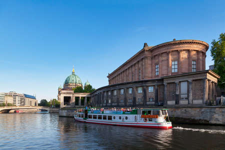 Berlin, Germany - June 02 2019: Boat passing in front of the Alte Nationalgalerie (Old National Gallery) with behind, the Friedrichs Bridge (FriedrichsbrÃ¼cke) and the Berlin Cathedral (Berliner Dom).のeditorial素材