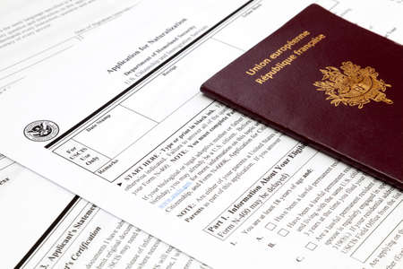 A French passport on the top of an American naturalization application form.の写真素材