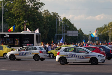 Bucharest, Romania - June 24 2018: Police cars parked in front of a protest for the 100 anniversary of the Greater Romania at Piata de Victoriei.のeditorial素材