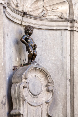 The Manneken Pis is a 17th century small bronze sculpture in Brussels, depicting a naked little boy urinating into a fountain's basin.の写真素材