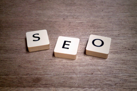 Lettered wooden tiles on plastic board displaying the accronym SEO.