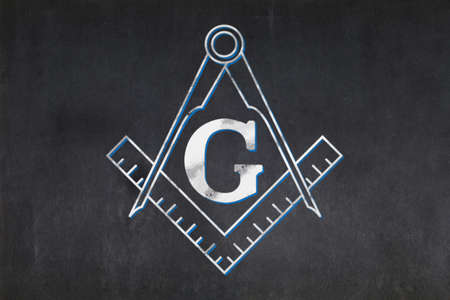 Blackboard with a the Masonic Square and Compasses drawn in the middle.の写真素材