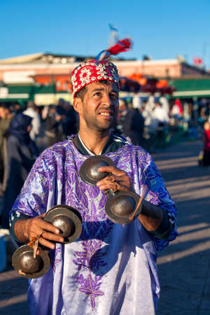 Marrakesh, Morocco - January 28 2019: Musician in traditional costume playing with a pair of Krakebs in Djemaa El Fna Square.のeditorial素材